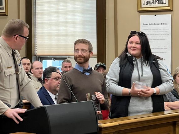 911 Emergency Communications Specialist Chris Bender and Daniella Lee listen as Undersheriff Jason Akerson describes how Daniella provided CPR to save her grandfather's life.