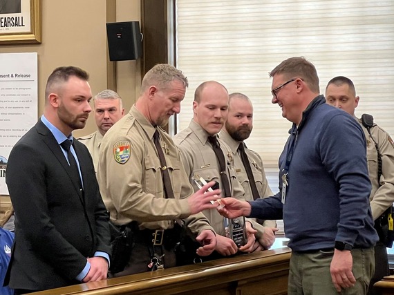 St. Louis County 911 Communications Center Supervisor Jason Matthias presents 911 Lifesaver Awards to (L-R): Deputies Dar Giancola, Blair Twaddle and Riley MacLean, Investigator Matt Miranda and Deputy Kyle Voltzke.