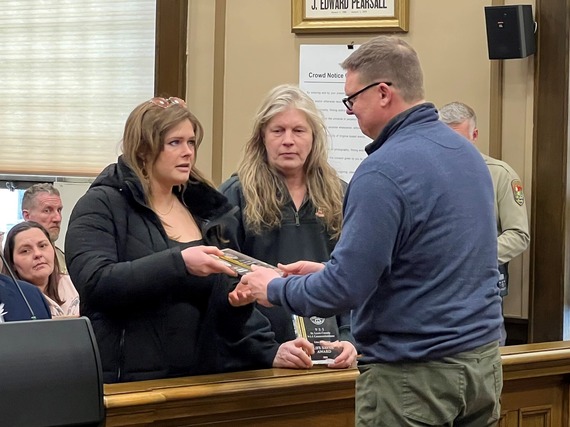 Amber and Lisa Reinking are presented 911 Lifesaver Awards for their quick actions to save two neighbors whose house had exploded.