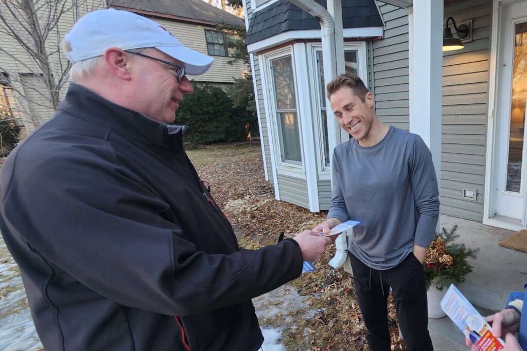 Paul Wikstrom visits with a Shoreview resident during a door-knock outing on a balmy evening late last month. | Alpha News 