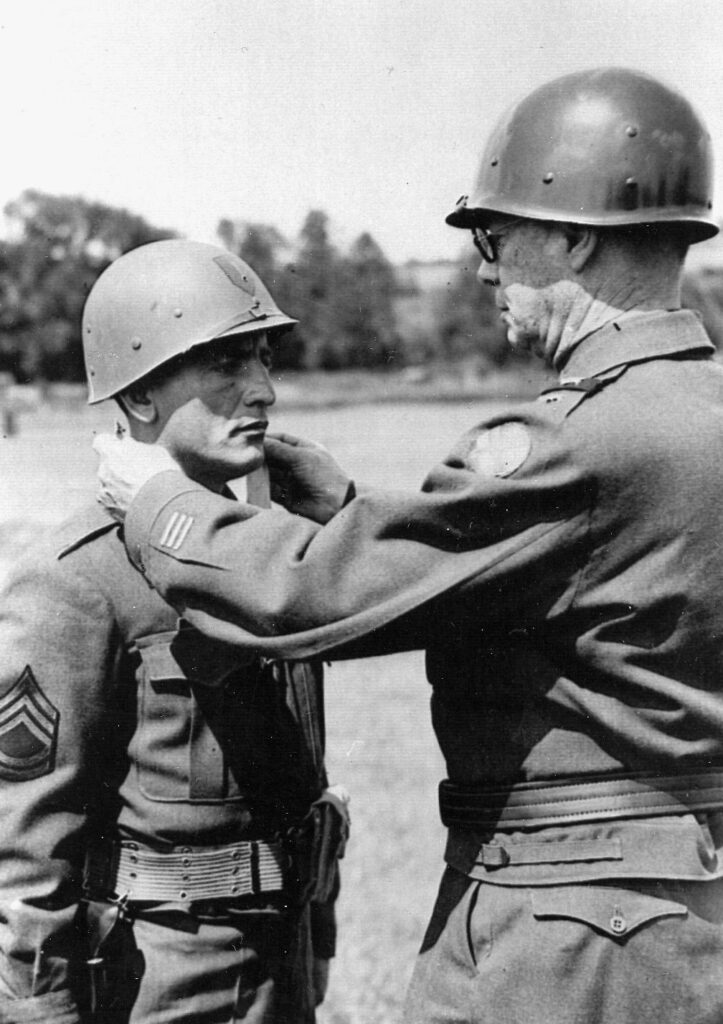 Seven Medals of Honor were awarded to American soldiers for heroism during the fighting in and around Aachen. Here Staff Sergeant Joseph E. Schaefer of Company I, 1st Infantry Division receives his nation’s highest award for bravery in combat.