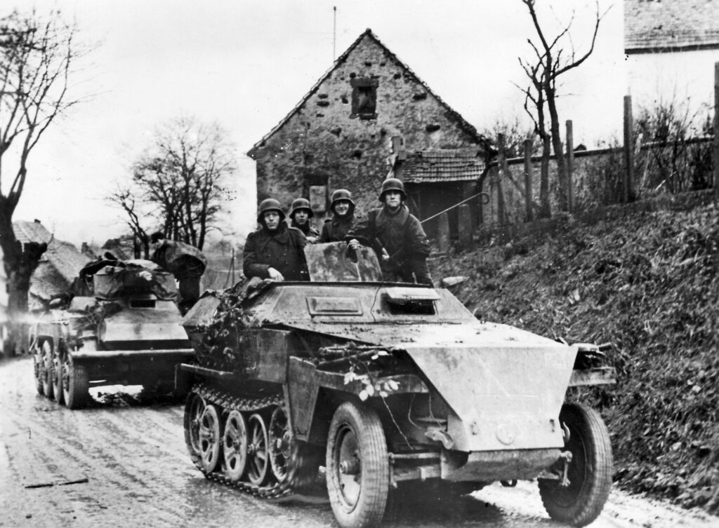 In October 1944, a German Schutzenpanzer half-track moves toward the fighting on the Western Front in company with a light tank. The German defense of Aachen, once the capital of the Holy Roman Empire, was tenacious. | ullstein bild