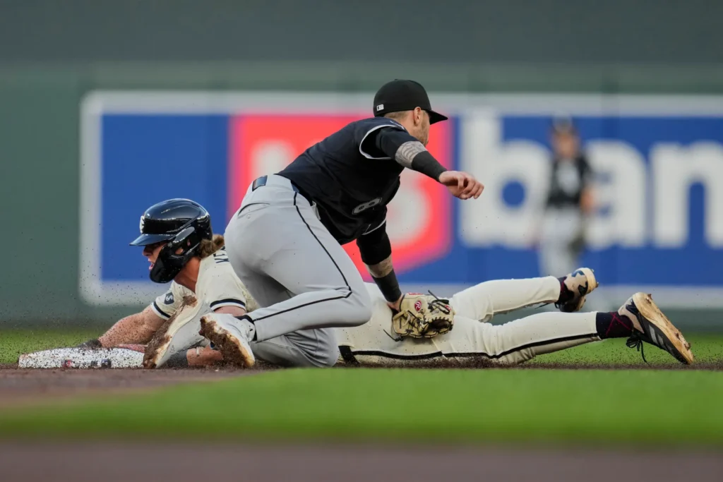 Minnesota Twins’ Luke Keaschall (15) beats the tag by Chicago White Sox shortstop Jacob Amaya (8) to steal second base during the third inning of a baseball game Tuesday, April 22, 2025, in Minneapolis. | AP Photo/Abbie Parr