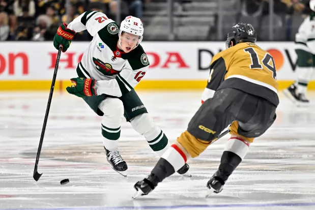 Minnesota Wild left wing Matt Boldy (12) skates against Vegas Golden Knights defenseman Nicolas Hague (14) during the third period of Game 2 of a first-round NHL hockey playoff series Tuesday, April 22, 2025, in Las Vegas. | AP Photo/David Becker